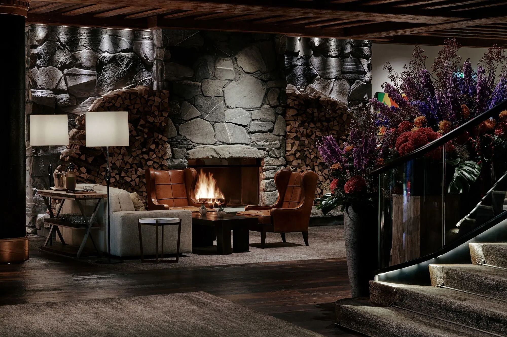 A lounge with a stone fireplace