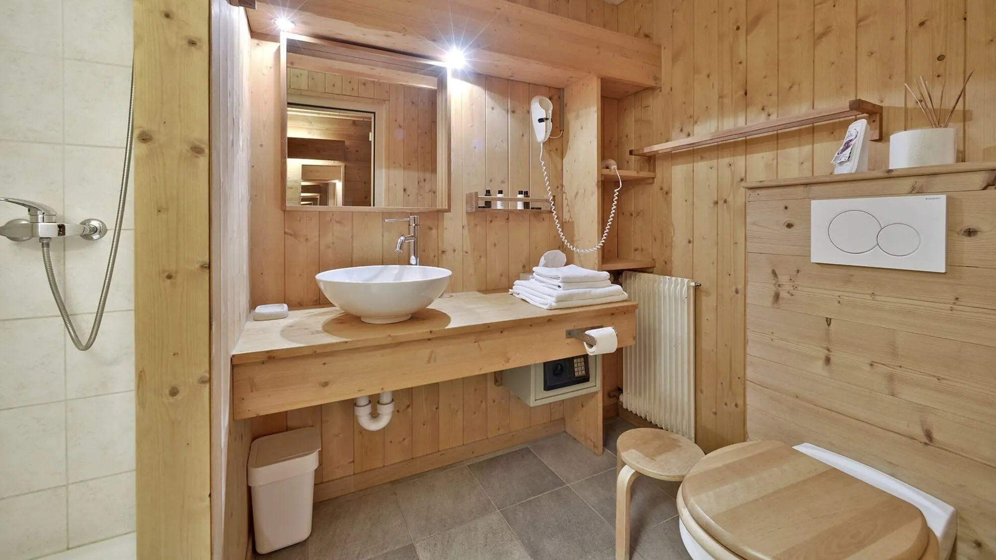 A wooden bathroom with a basin
