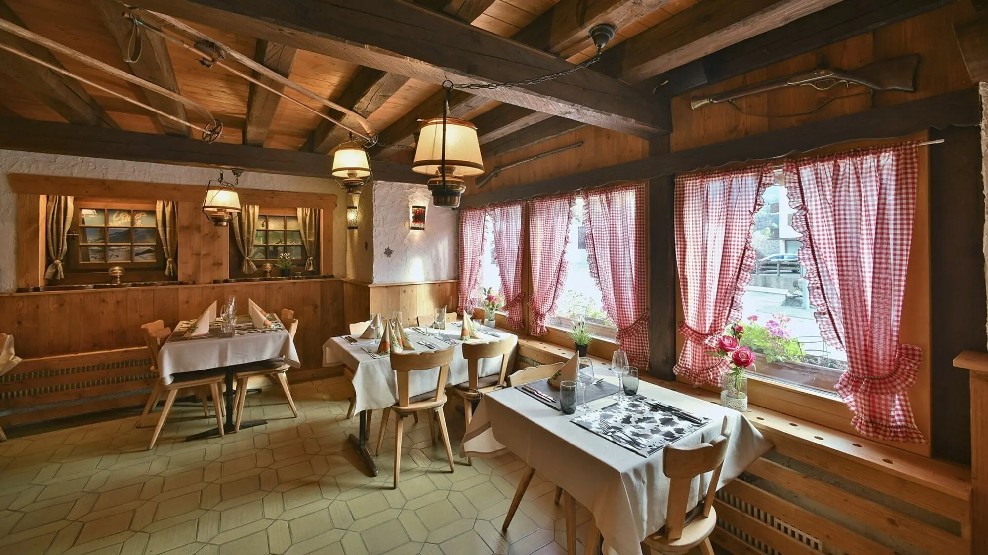 Restaurant tables by gingham curtains