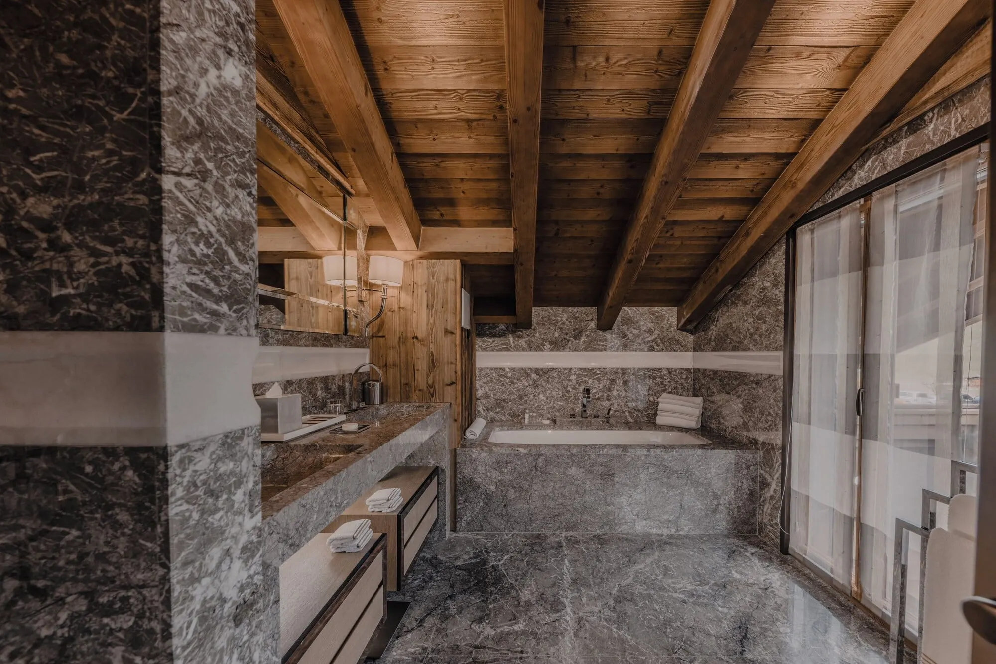 A marble bathroom with a bathtub