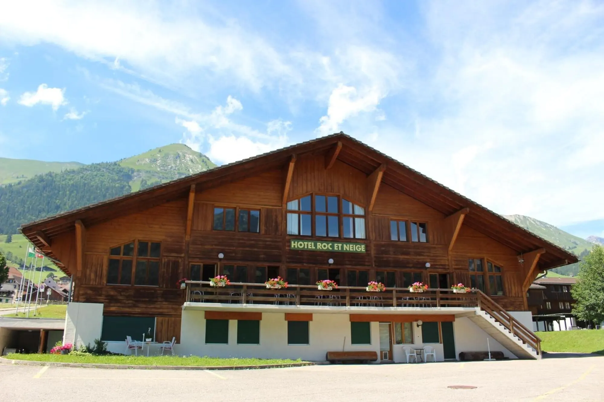 The chalet hotel below the mountains in summer