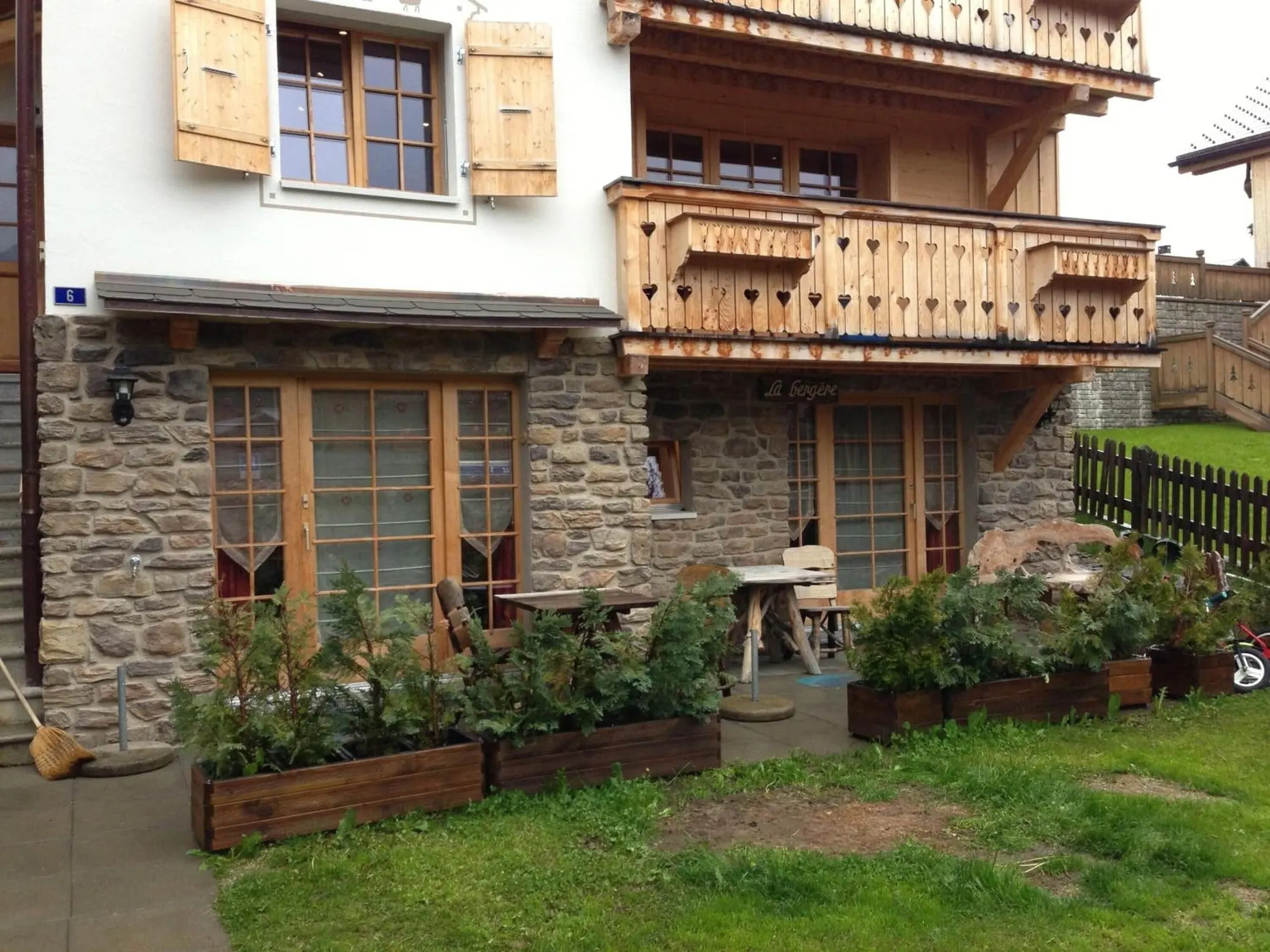 A stone wing with balconies and flowers