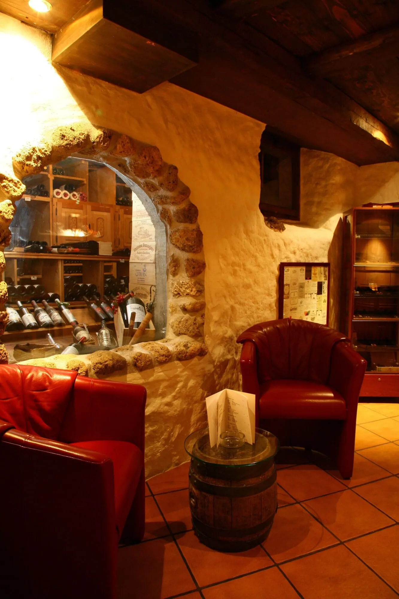 A stone-walled lounge with a wine rack