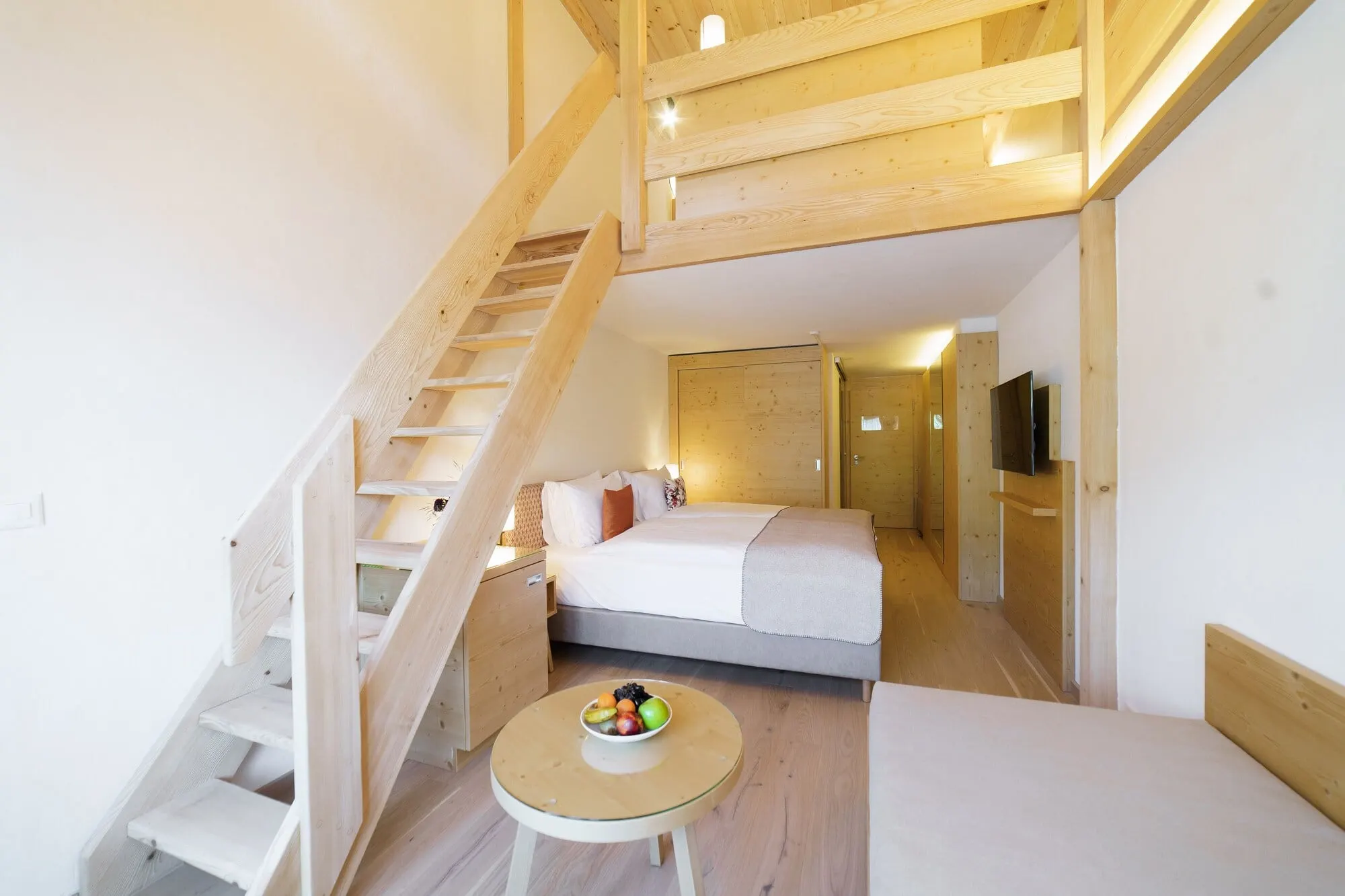 A duplex room with stairs to the upper level