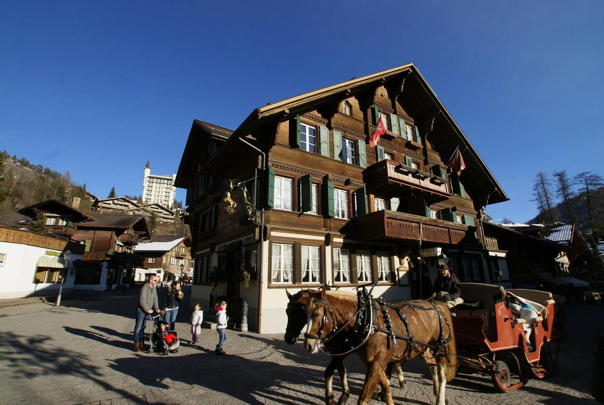 The hotel in summer with a horse carriage