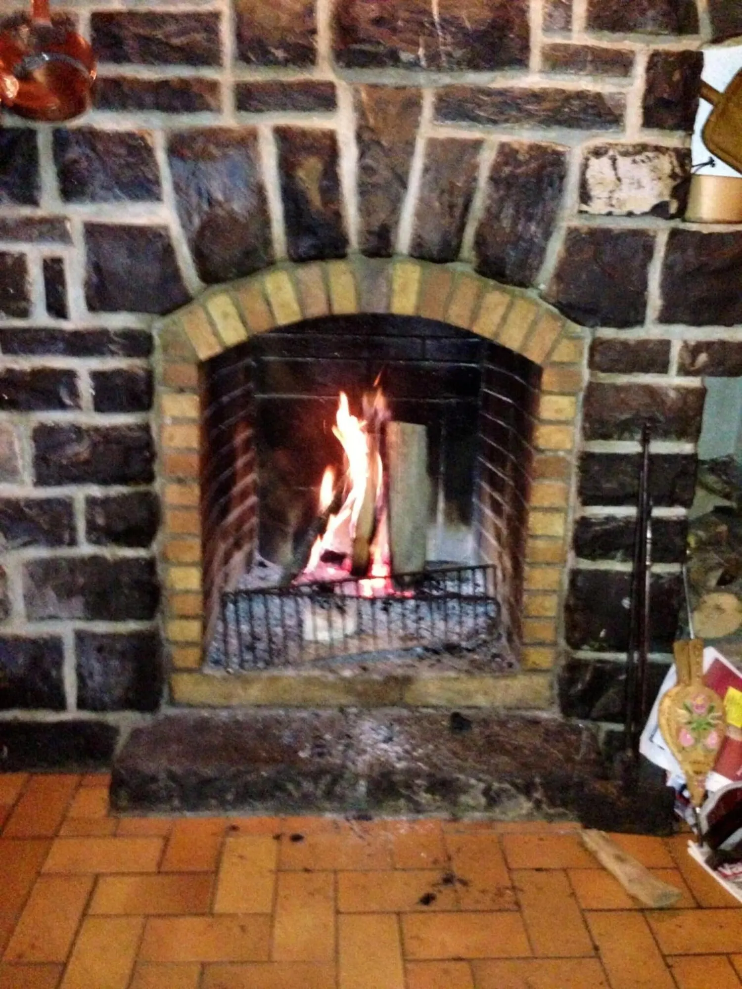 An open fire in a stone fireplace