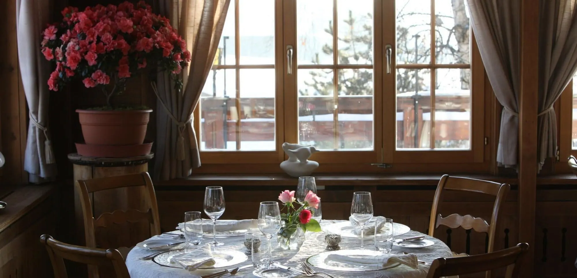 A table by the window with flowers