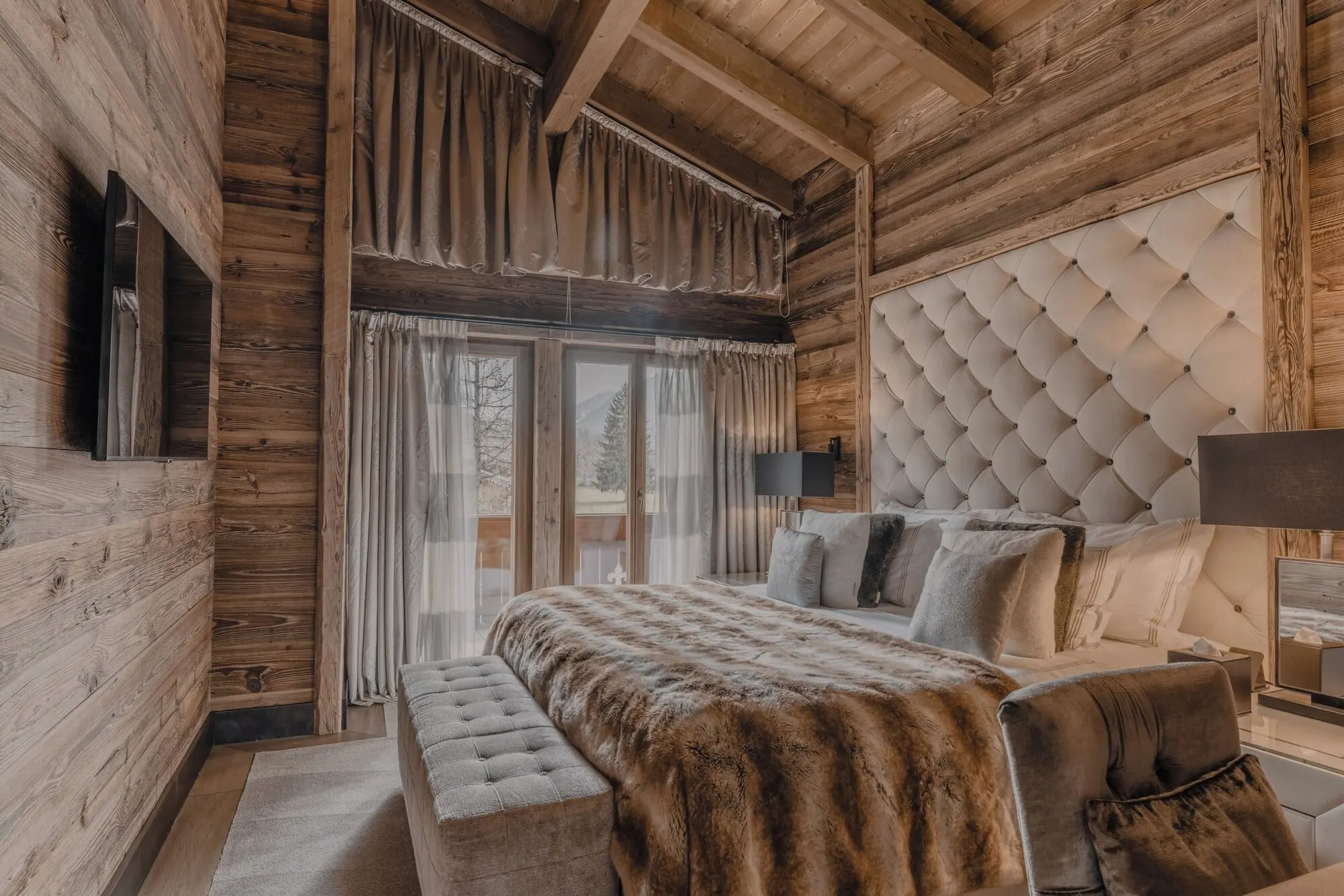 A bedroom with a padded headboard