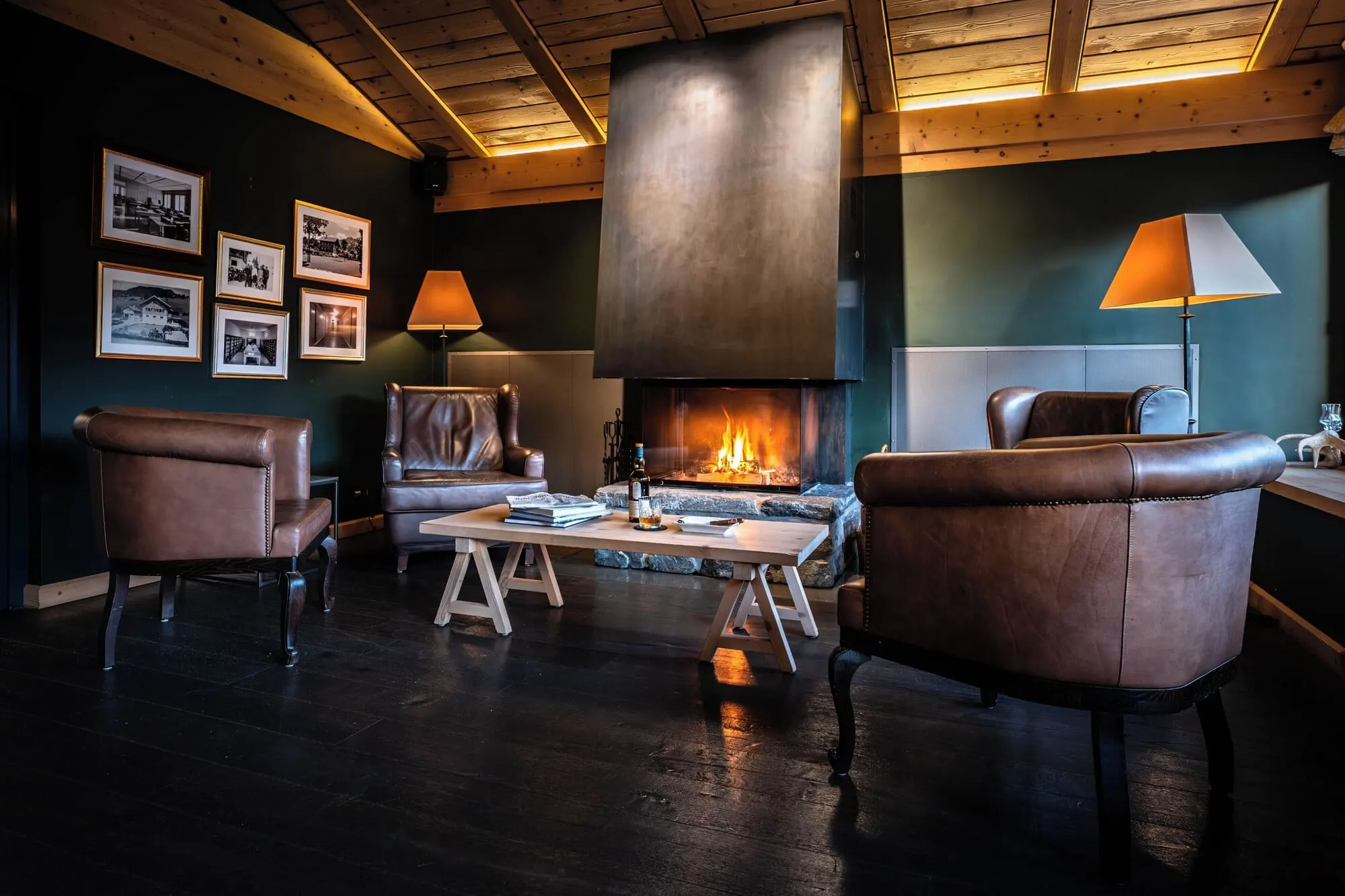 A lounge with leather chairs and a fire