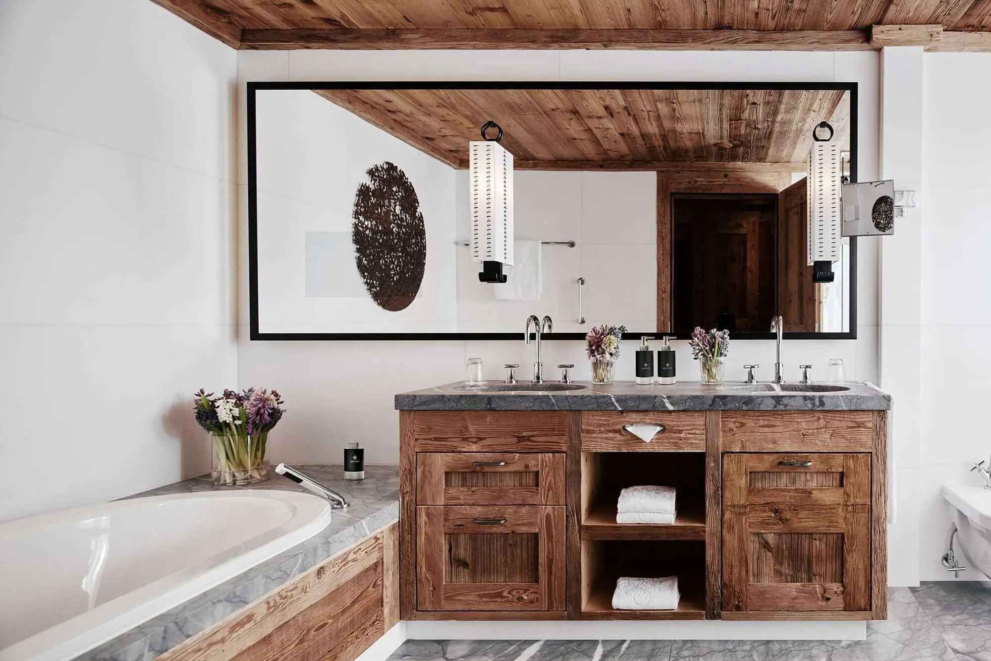 A bathroom with a bathtub and wooden vanity