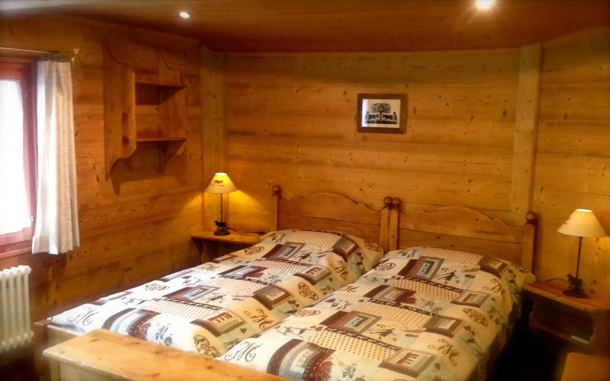 A wooden room with a double bed