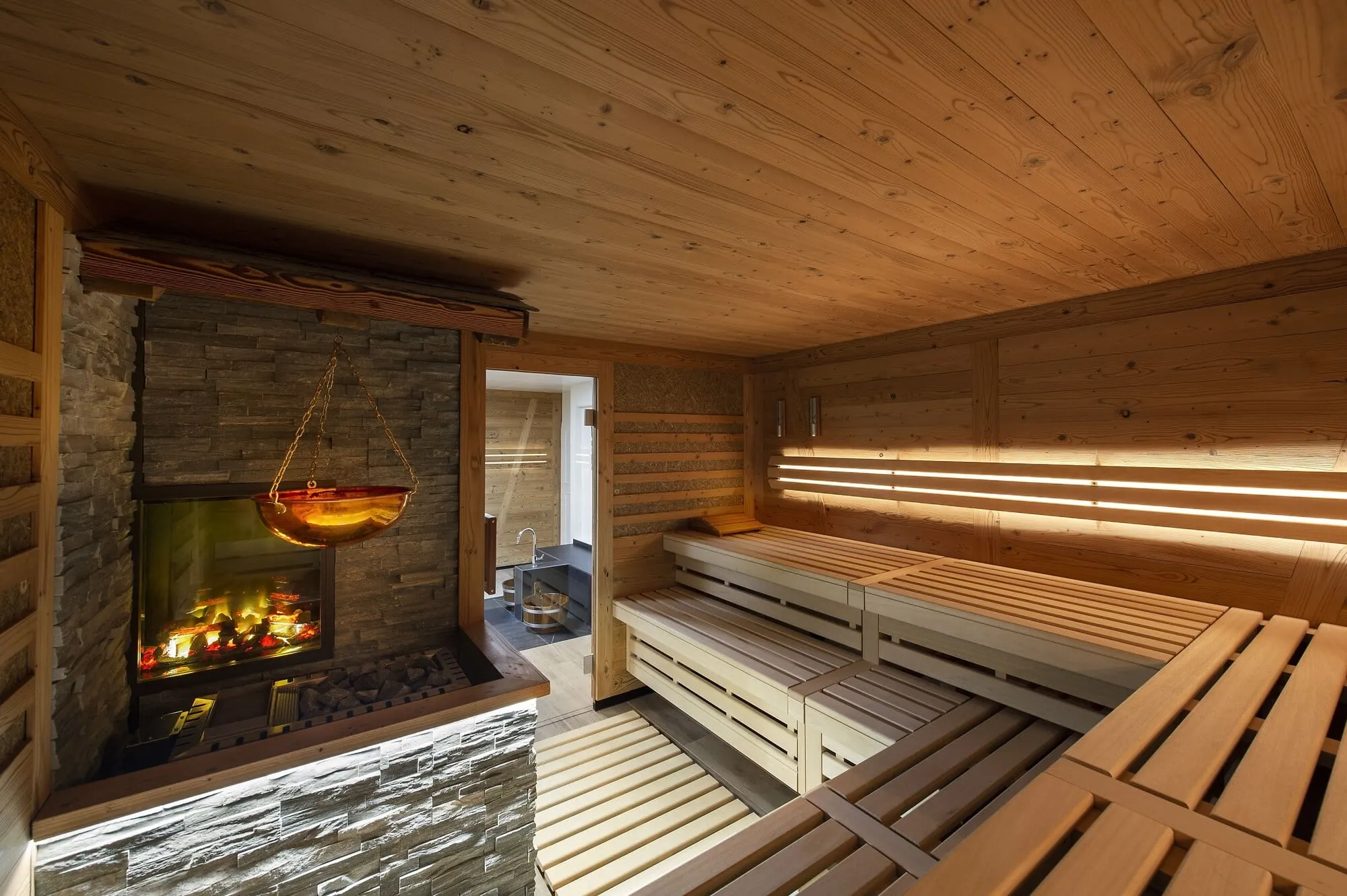 A sauna with a fireplace