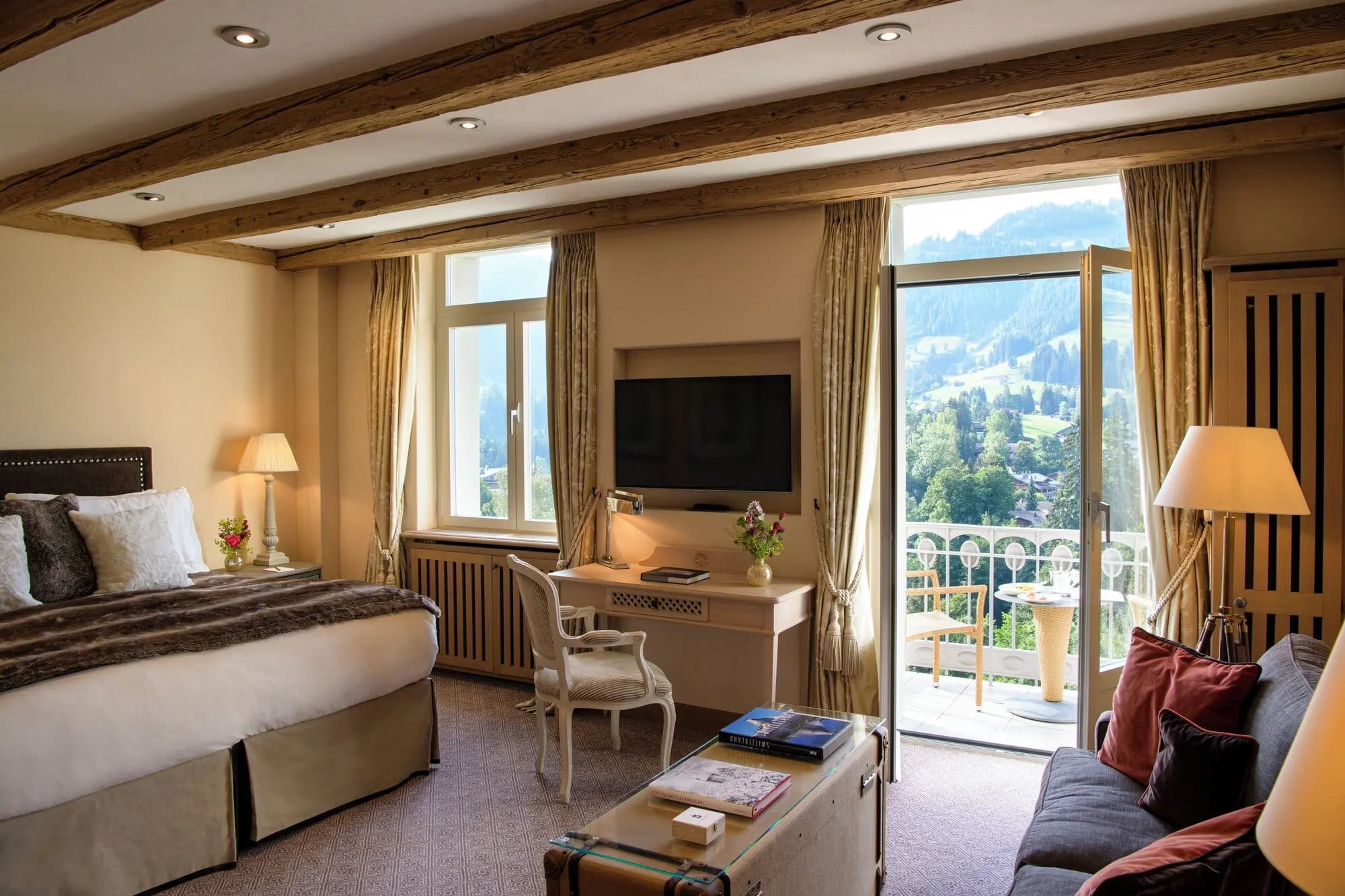 A room with a balcony and valley view