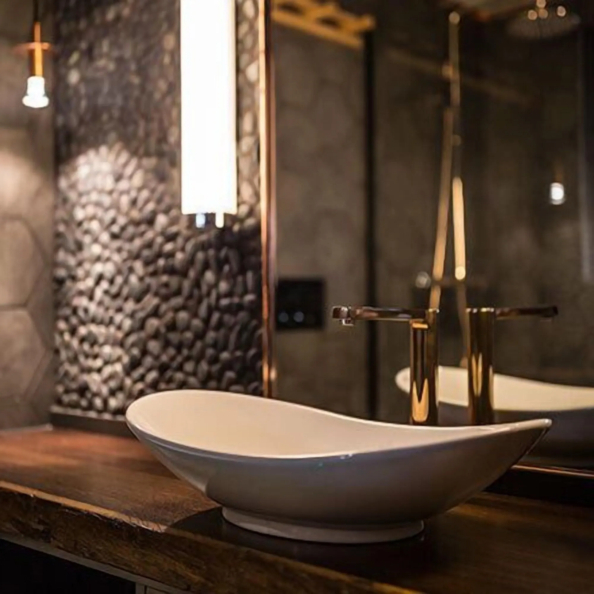 A bathroom with a stone wall and bathtub