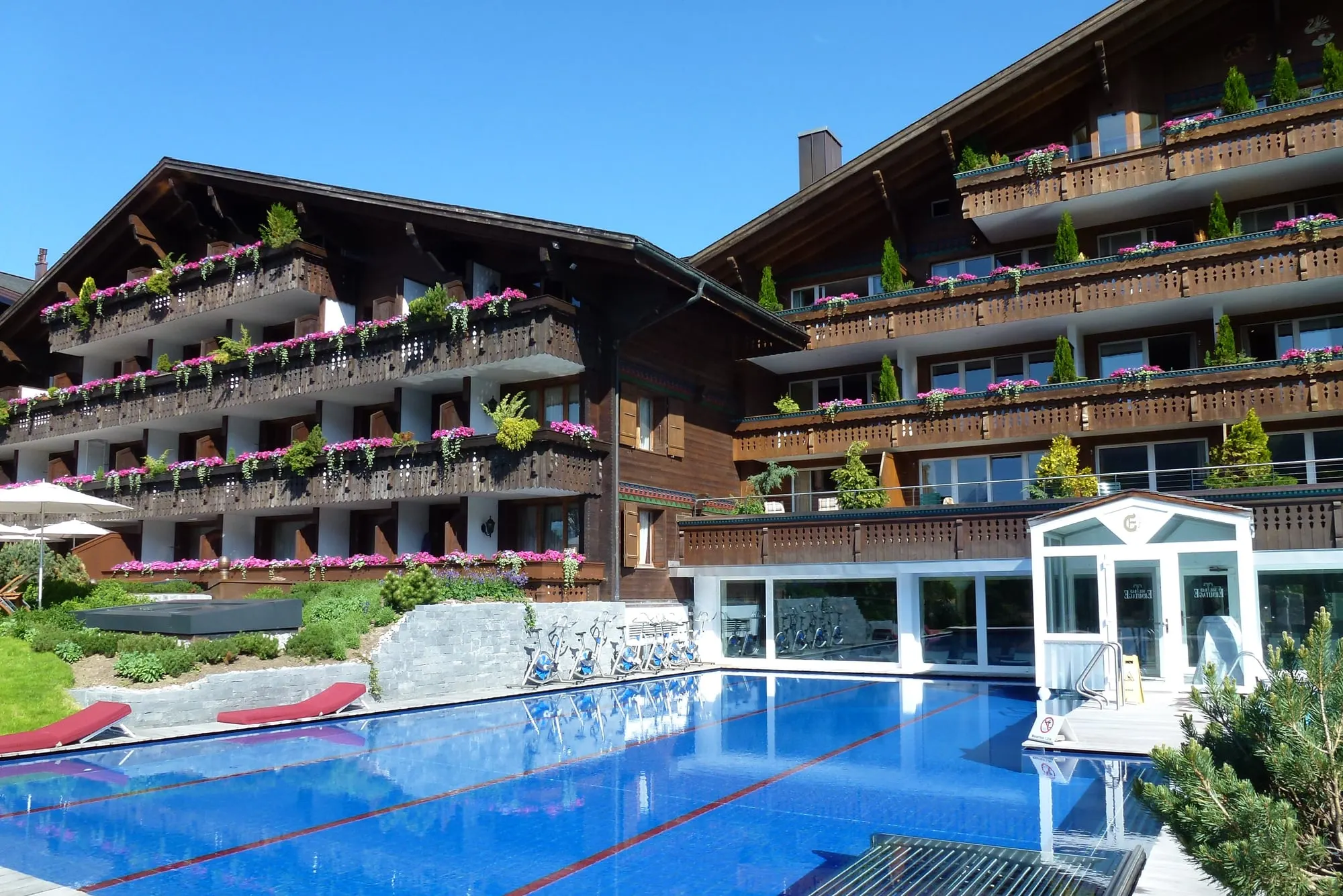 Ermitage chalet wings above the heated outdoor pool in summer