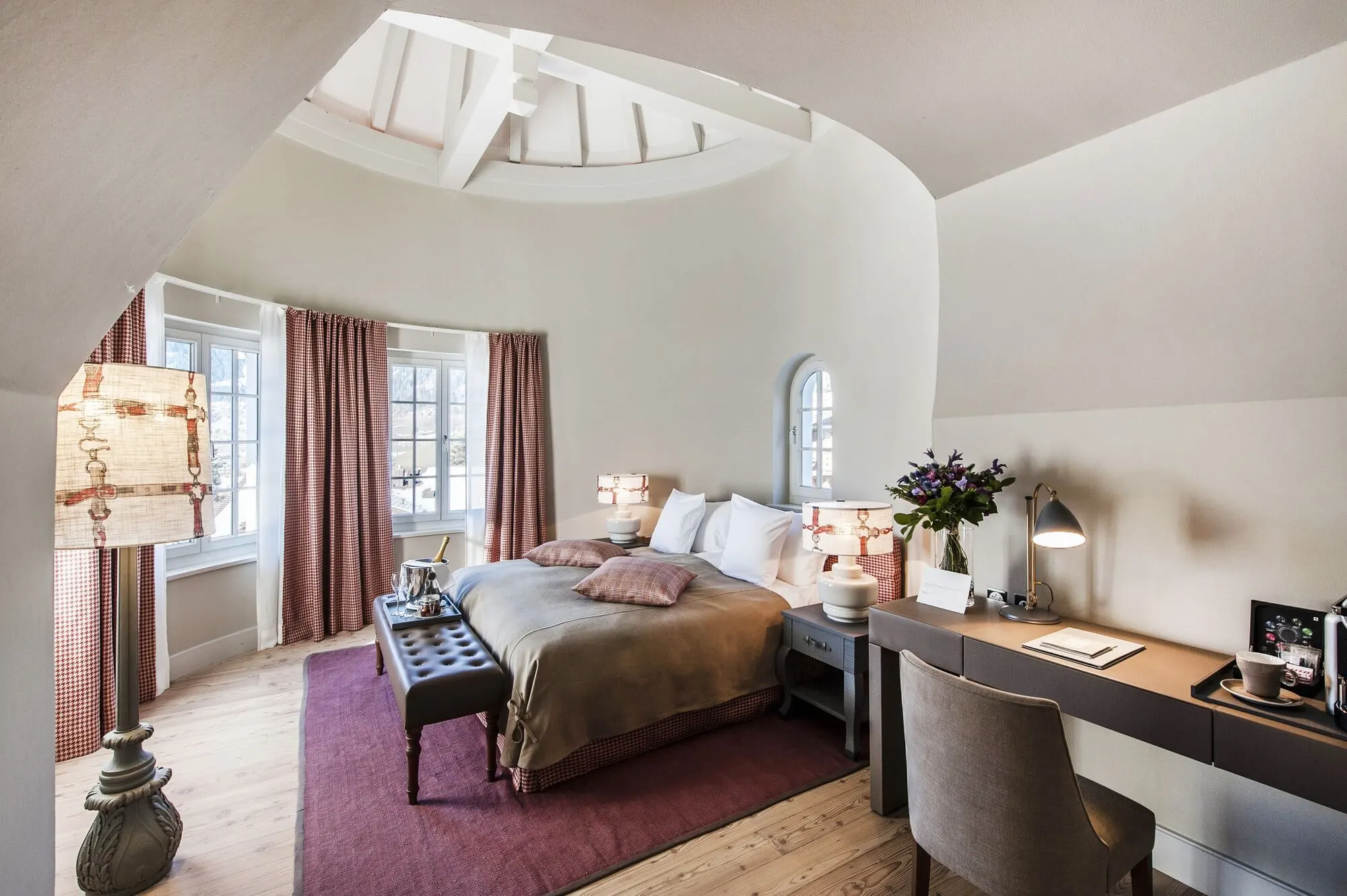 A bedroom with a desk and sofa