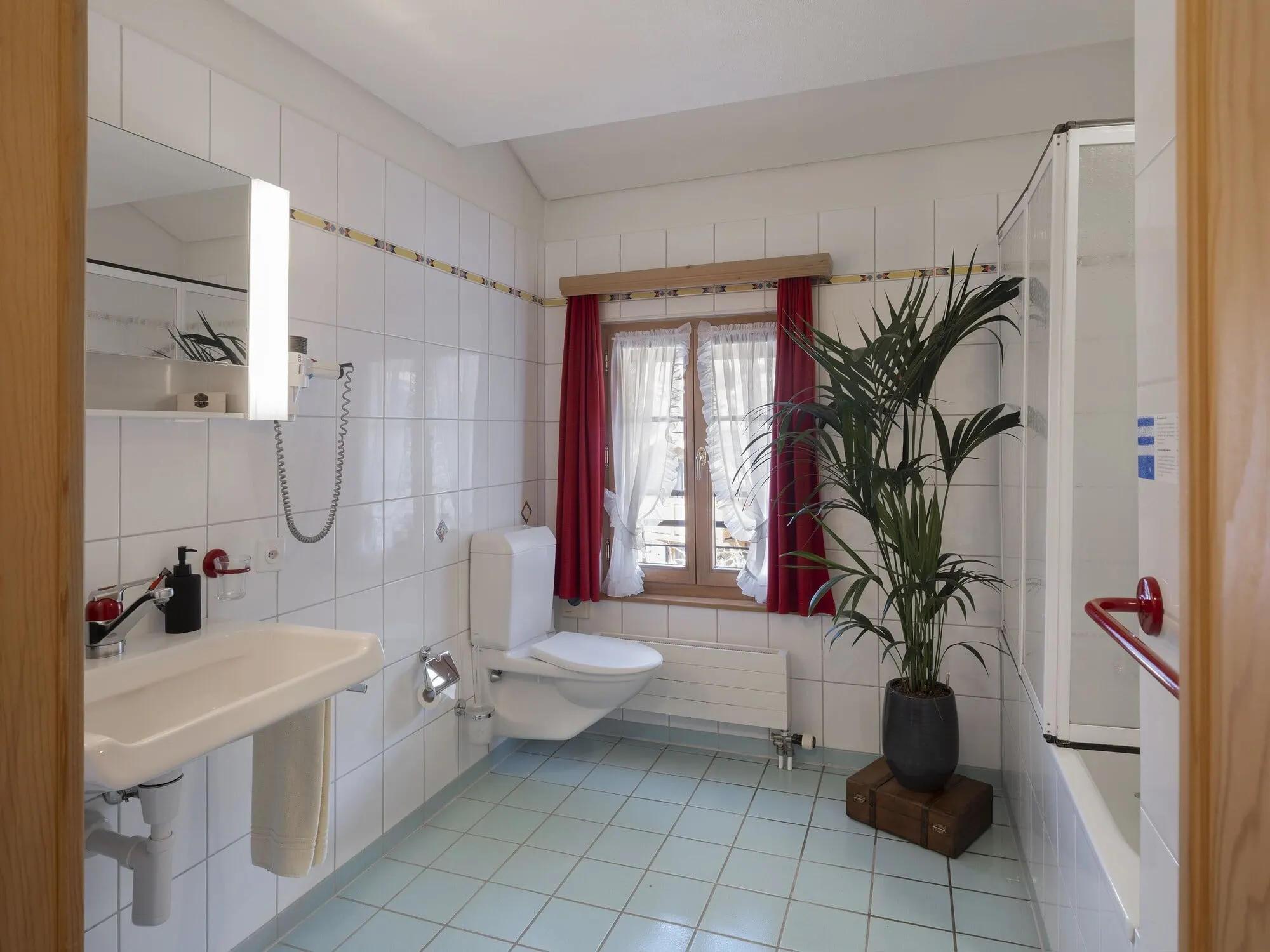 A bright bathroom with a shower