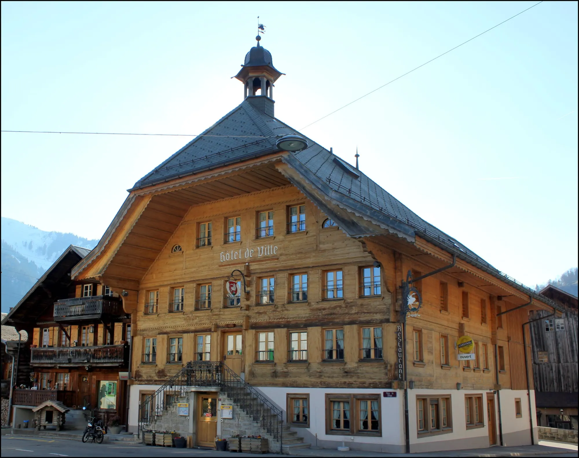 Wooden Hôtel de Ville with its bell turret on the Rossinière village square