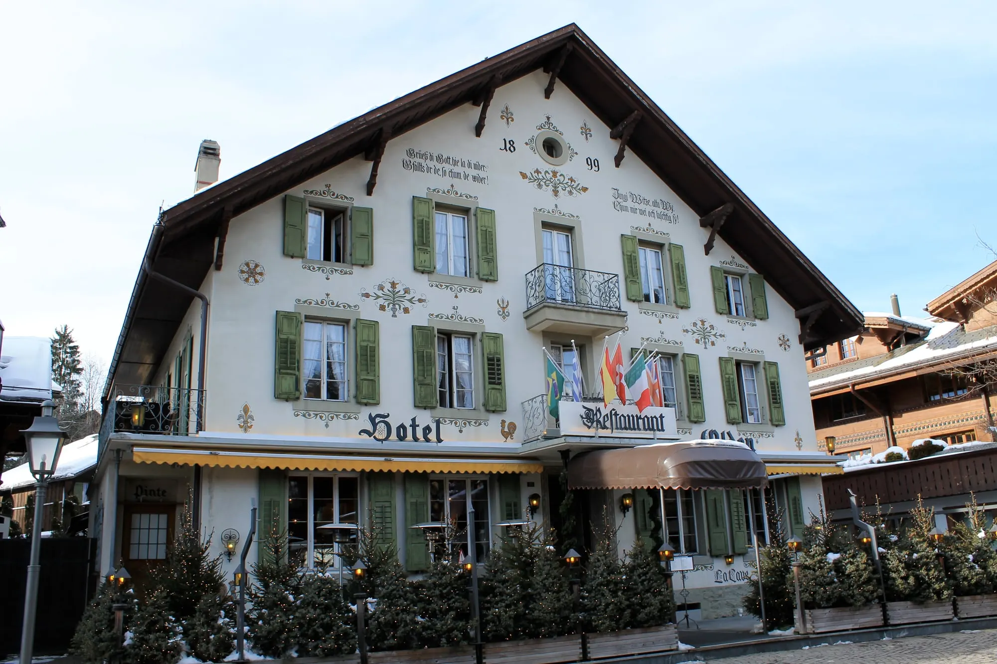 Painted 1899 facade of Hotel Olden on the Gstaad Promenade in winter